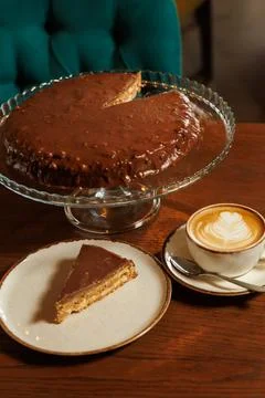 Slice of Homemade cold daim cake with chocolate and nuts with coffee on table Stock Photos