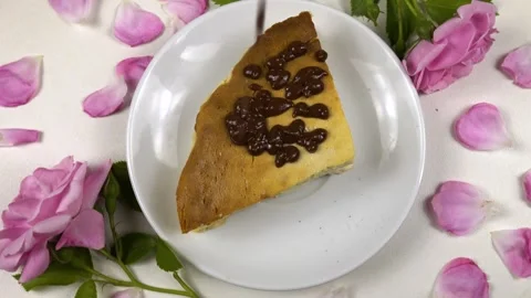 A slice of homemade cottage cheese pie is being covering with chocolate icing Stock Footage 337403131