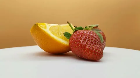 Slice of juicy orange and two red strawberries Stock Footage 167981064