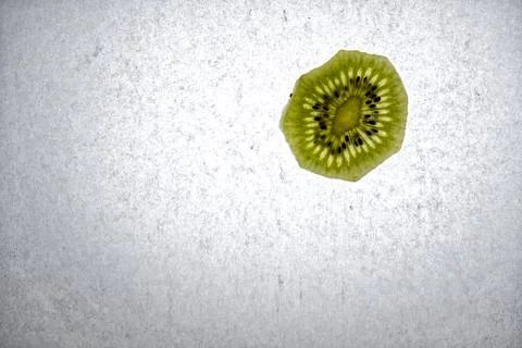 A slice of kiwi fruit with backlight Stock Photos