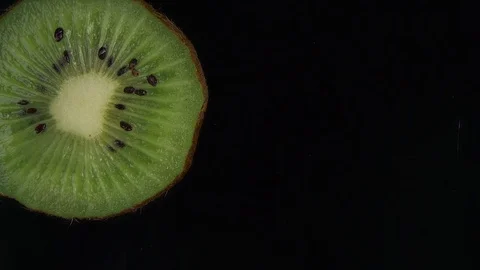Slice of Kiwi fruit falling in slow motion Stock Footage 83497426