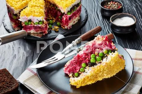 A slice of layered cake salad, close-up Stock Photos