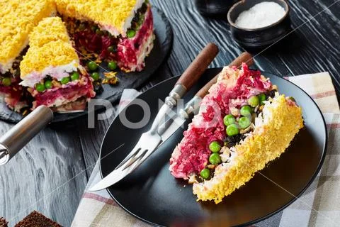 Slice of layered cake salad on a plate Stock Photos