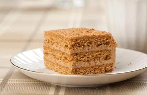 Slice of layered honey cake Stock Photos