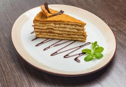 Slice of layered honey cake Stock Photos