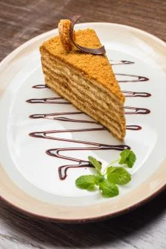 Slice of layered honey cake Stock Photos