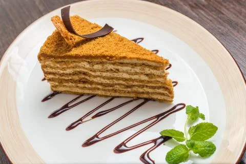 Slice of layered honey cake Stock Photos