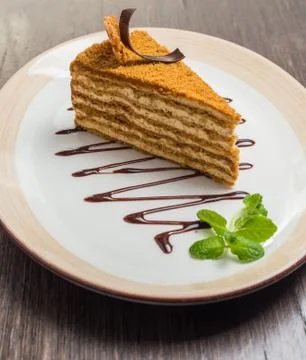 Slice of layered honey cake Stock Photos