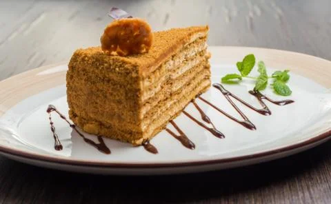 Slice of layered honey cake Stock Photos