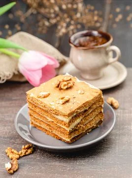 Slice of layered honey cake selective focus Stock Photos