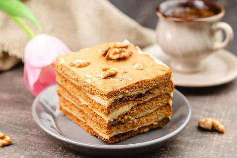 Slice of layered honey cake selective focus Stock Photos