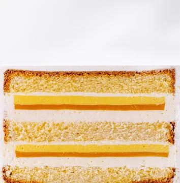 Slice of layered vanilla cake with mango lemon curd Stock Photos