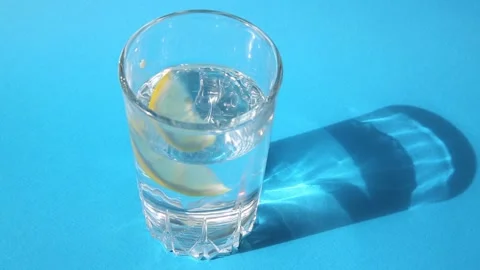 A slice of lemon is added to clean drinking water and stirred with a spoon. Stock Footage 165325209
