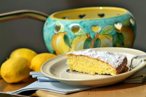 Slice of lemon cake on cake server Stock Photos