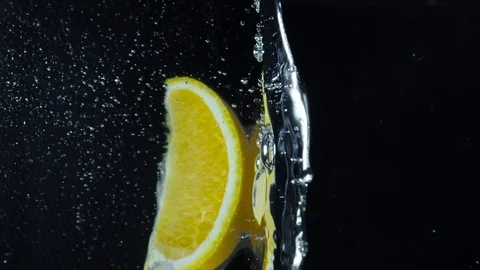 A slice of a lemon fall into the water Stock Footage 118132869