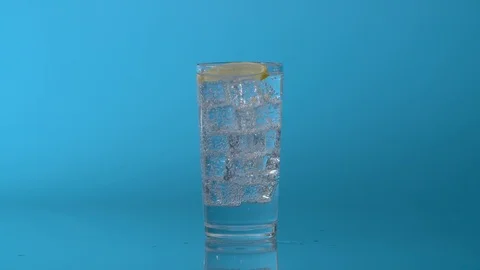 A slice of lemon falling in a glass Stock Footage 123993810