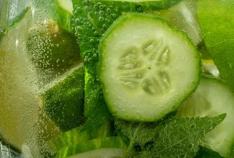 Slice of lemon, lime, cucumber. drop into a sparkling carbonated water, a ref Stock Photos