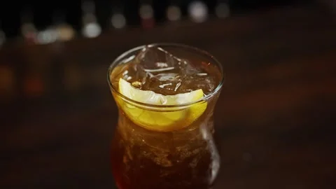 Slice of lemon on top of a custom alcohol drink Stock Footage 301411588