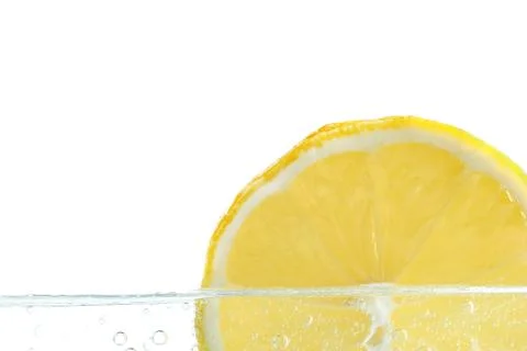 Slice of lemon in water . Stock Photos