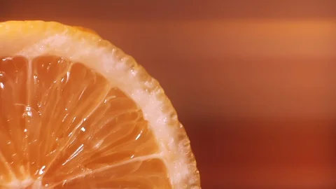 A slice of lemon is watered with water, macro closeup. Healthy food Stock Footage 127853017
