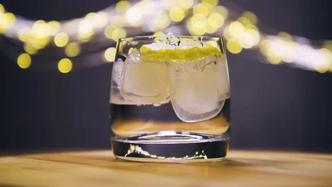 Slice of lemon,lime dropped into glass full of water Stock Footage 128699684