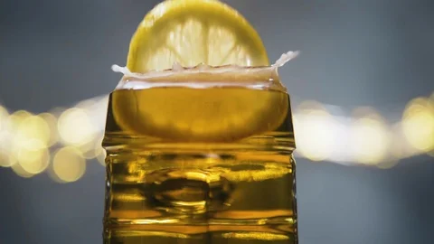 Slice of lemon,lime dropped into glass full of beer Stock Footage 128729876