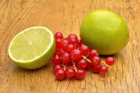 Slice of lime and red currant Stock Photos