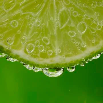Slice of lime in the bubbles Fotos de archivo