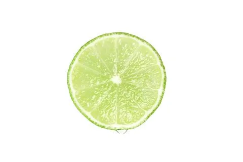 Slice of lime with juice drip. Stock Photos