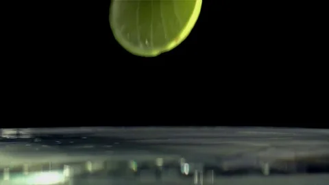 Slice of Lime splashing into water Stock Footage 70090087