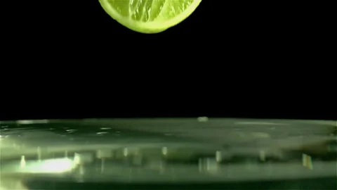 Slice of Lime splashing into water Stock Footage 70091809