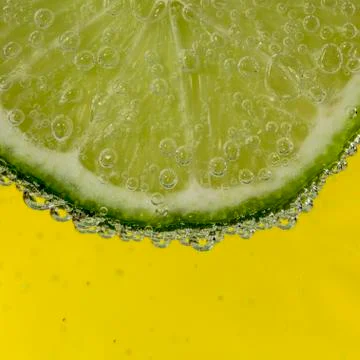 Slice of lime in the water Stock Photos