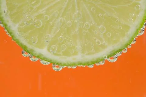 Slice of lime in the water Stock Photos
