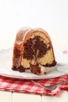 Slice of marble cake sprinkled with icing sugar Stock Photos
