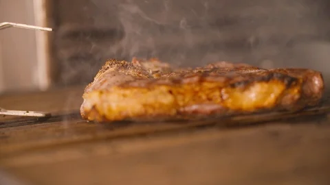 Slice of meat being removed from the grill with tongs Video stock 85812336