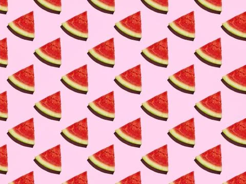 Slice of Mini Watermelon pattern on a pink background with a hard shadow Stock Photos