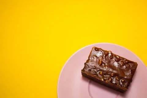 Slice of mousse cake on a yellow background Stock Photos
