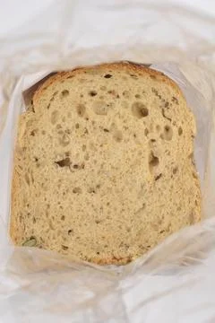 Slice of multi seed bread in plastic bag Stock Photos