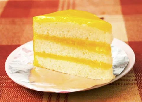 Slice of orange cheese cake Stock Photos