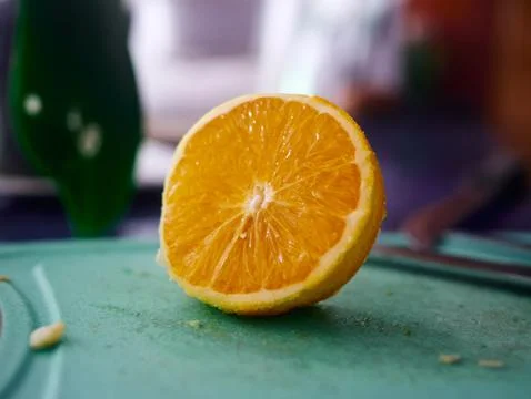 Slice of orange is on a cutting board Stock Photos