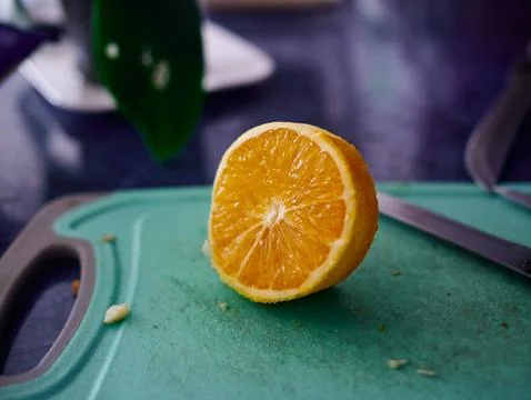 Slice of orange is on a cutting board Stock Photos