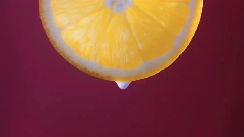A slice of orange with drops of juice Stock Footage 238616948