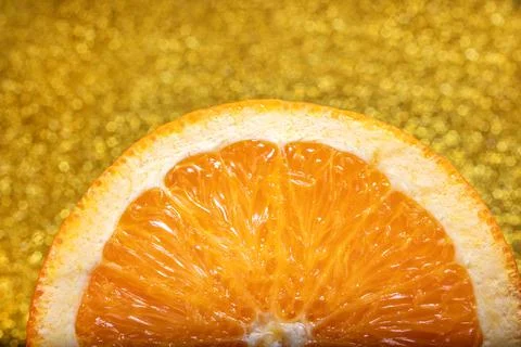 Slice of Orange on Golden Background Stock Photos