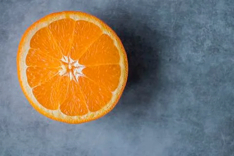 Slice of orange  on gray background. Citrus fruit. Stock Photos