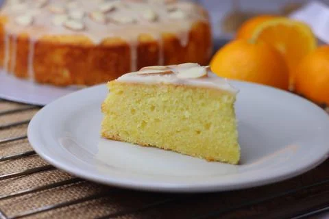 Slice of orange pound cake with sugar orange glaze and almonds served on a .. Stock Photos