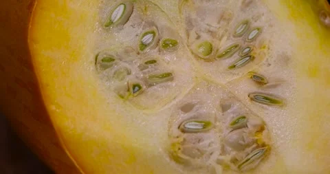 Slice orange ripe pumpkin or zucchini, slicing ripe zucchini on a black cooking Stock Footage 304580896