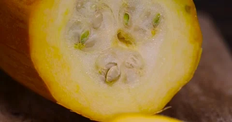 Slice orange ripe pumpkin or zucchini, slicing ripe zucchini on a black cooking Stock Footage 311900022