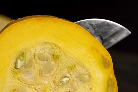 Slice orange ripe pumpkin or zucchini, slicing ripe zucchini on a black cooki Stock Photos