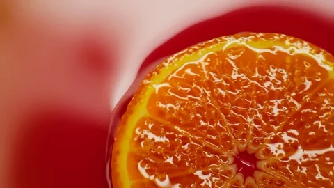 Slice of orange rotating close-up on red background Stock Footage 125885341