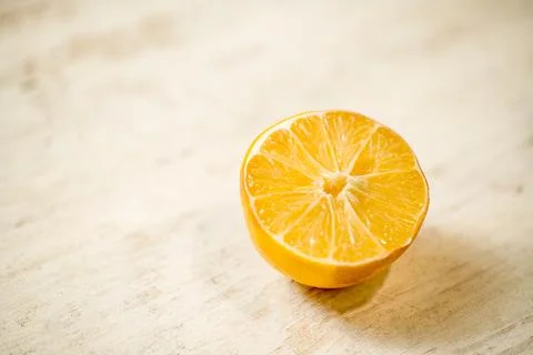 A slice of orange is on a table Stock Photos